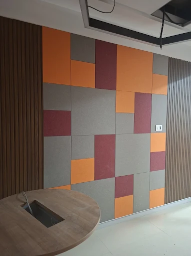 Color-block acoustic wall panels in an office meeting area